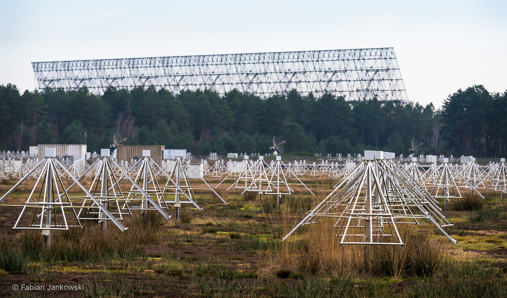 View of the NenuFAR (front) and LOFAR FR606 telescopes (middle), with the Nançay Radio Telescope (NRT) in the background.